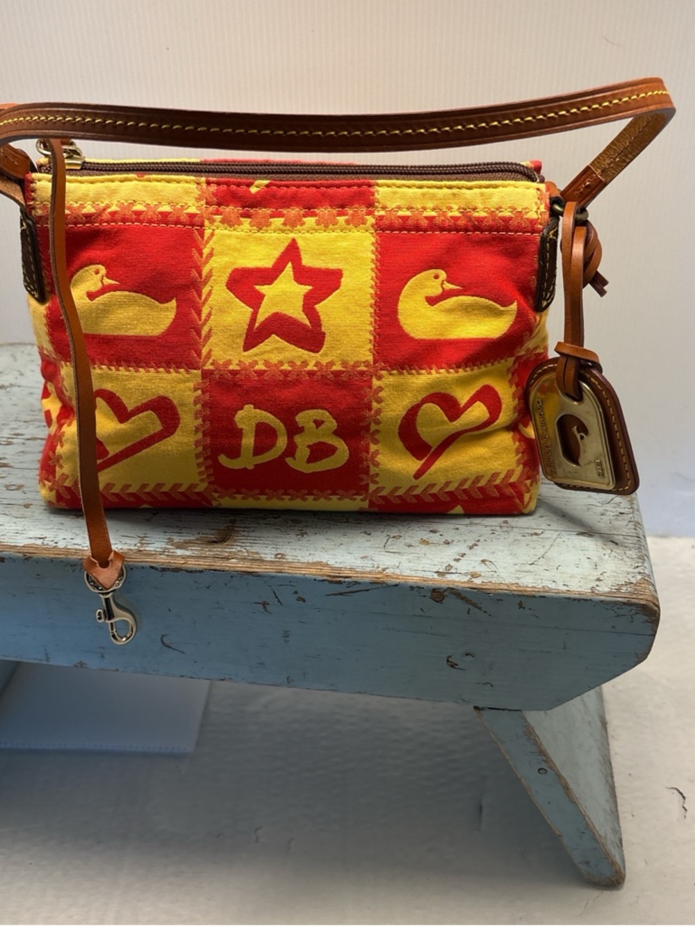 Dooney & Bourke Red and Yellow Patchwork Satchel with leather handle.